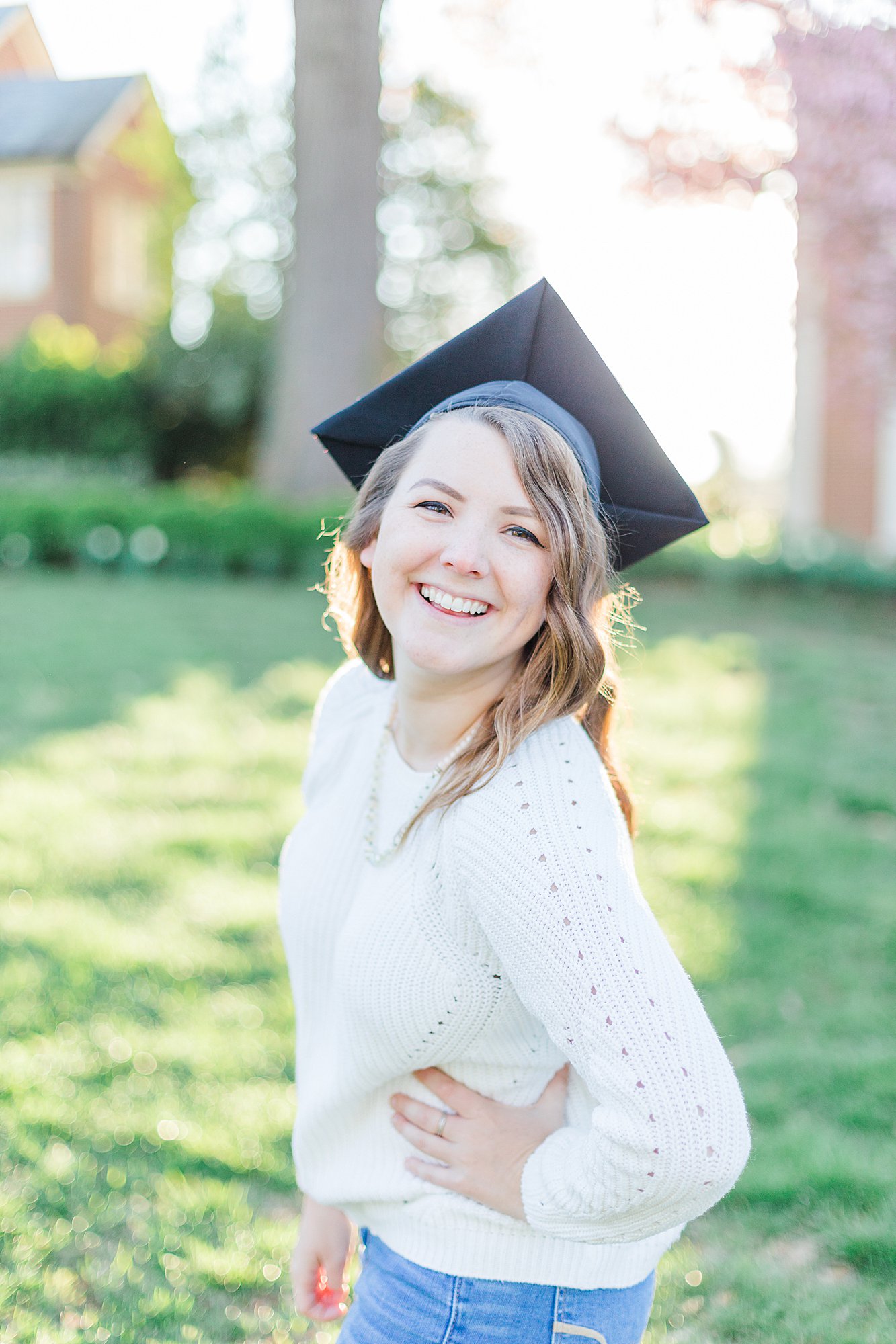 Girl wearing graduation cap smiling for camera.