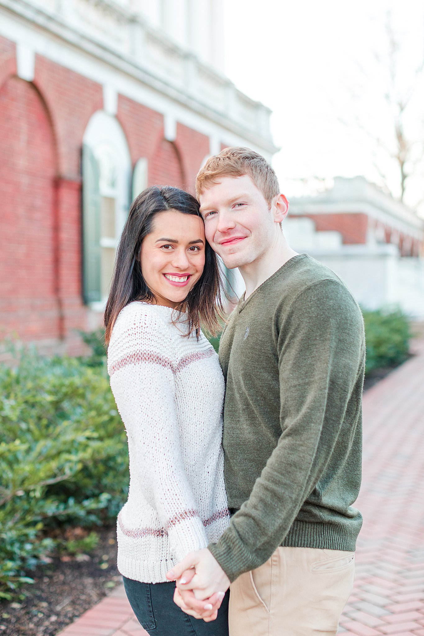 Couple smiling for engagement photos at UVA