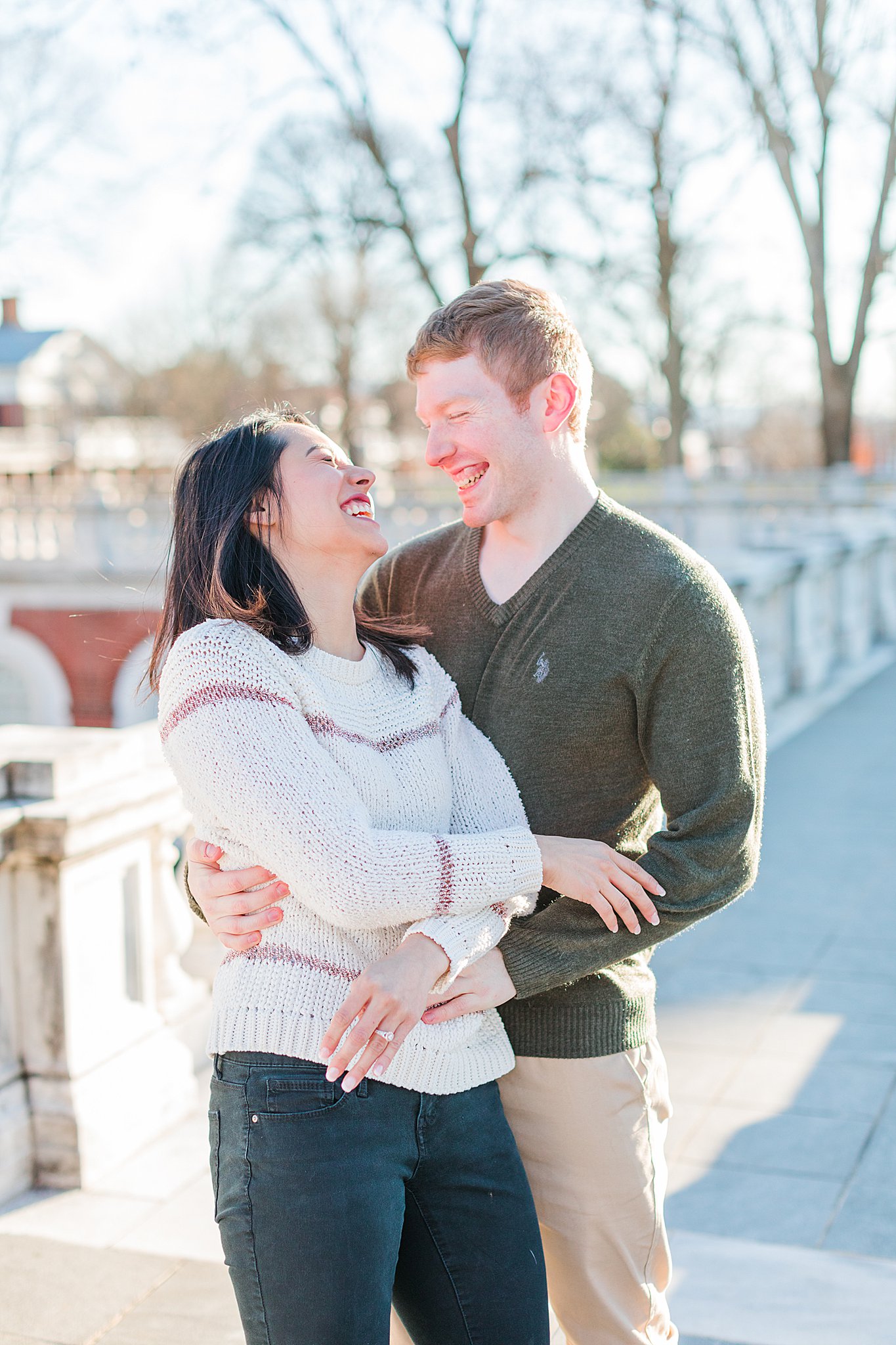 Couple smiling for engagement photos at UVA