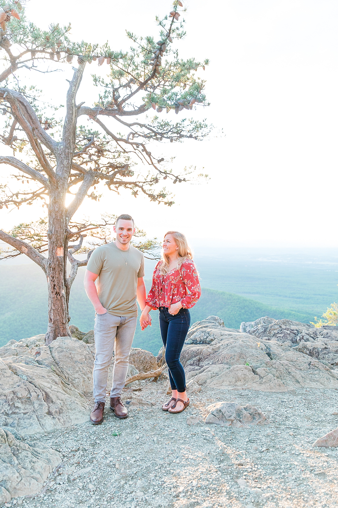 Couple smiling for engagement session.