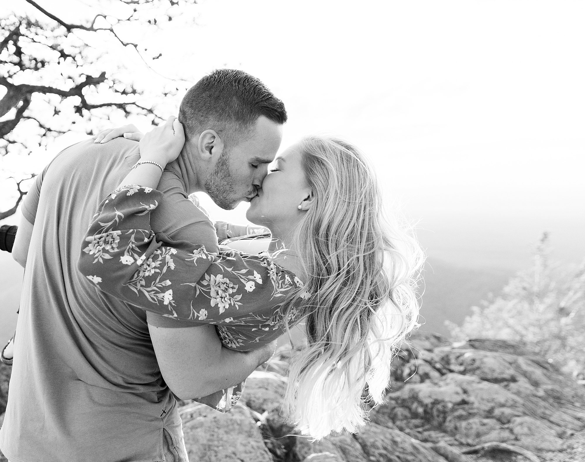 Couple kissing for photo during Ravens Roost engagement session.