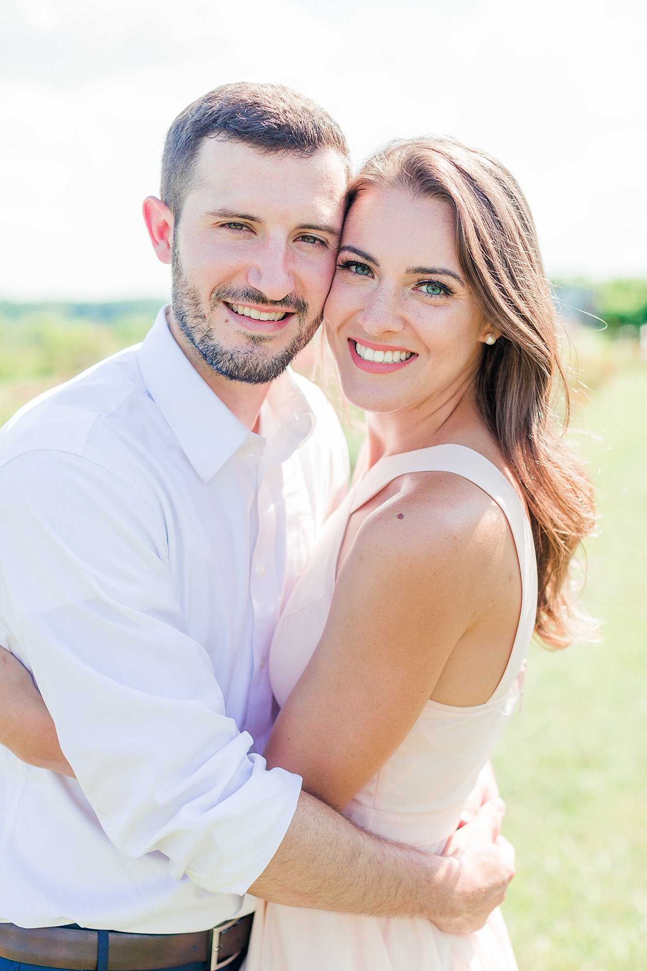 Couple smiling at camera for Charlottesville, VA engagement photos.