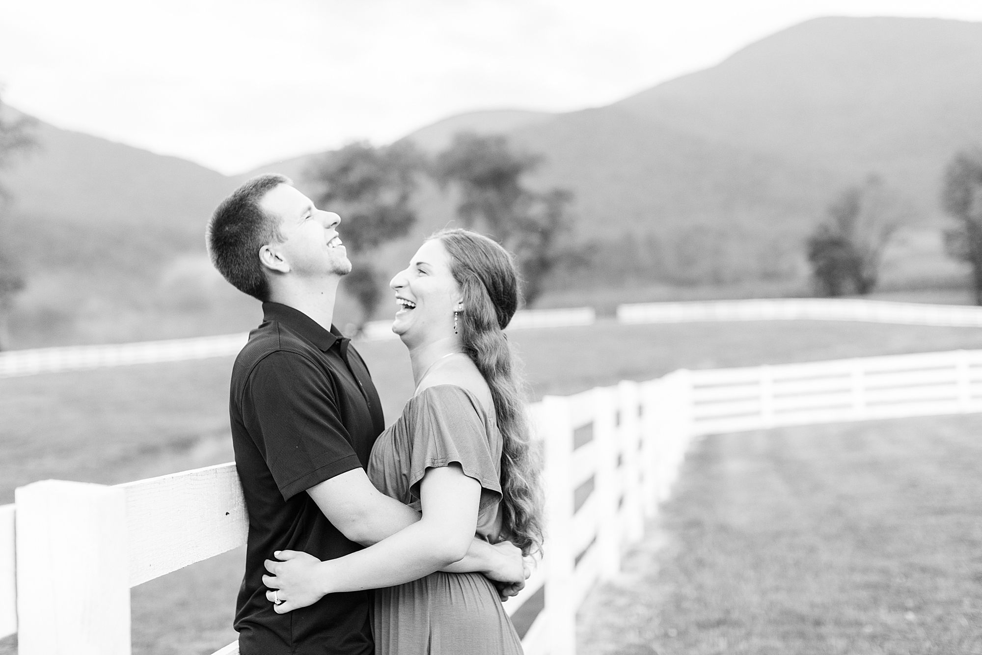 Candid engagement photo of couple laughing.