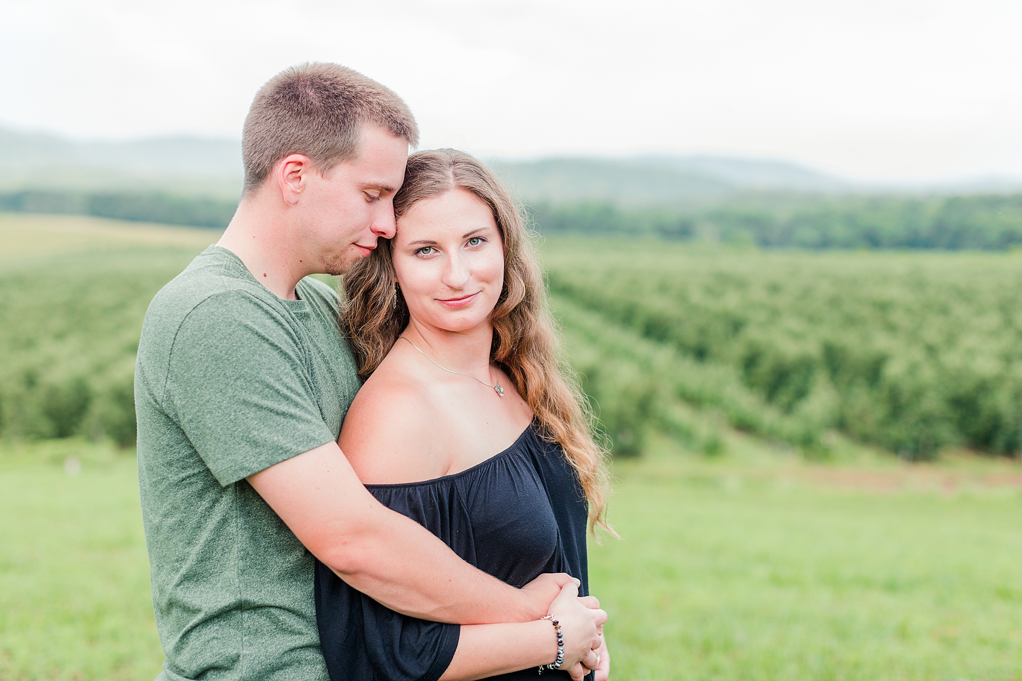 Virginia vineyard in background of couple taking photo.