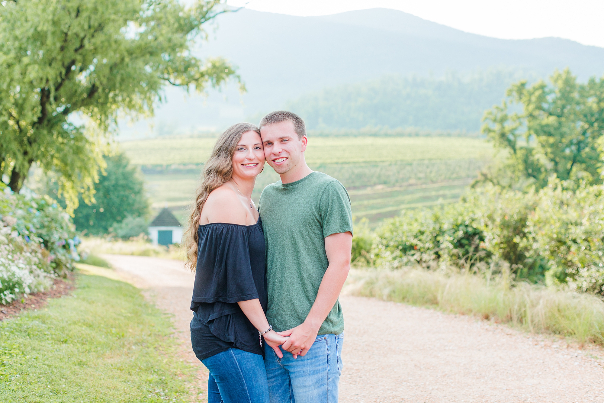 Couple posing for photo in Blue Ridge Mountain and venue called Pharsalia.