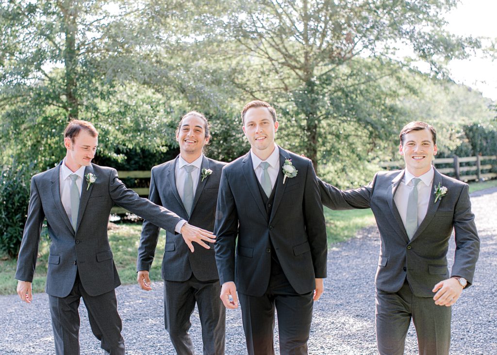 Walking towards camera giving groom high-five.