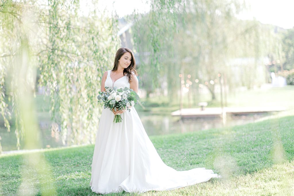 Portrait of bride under willow tree.