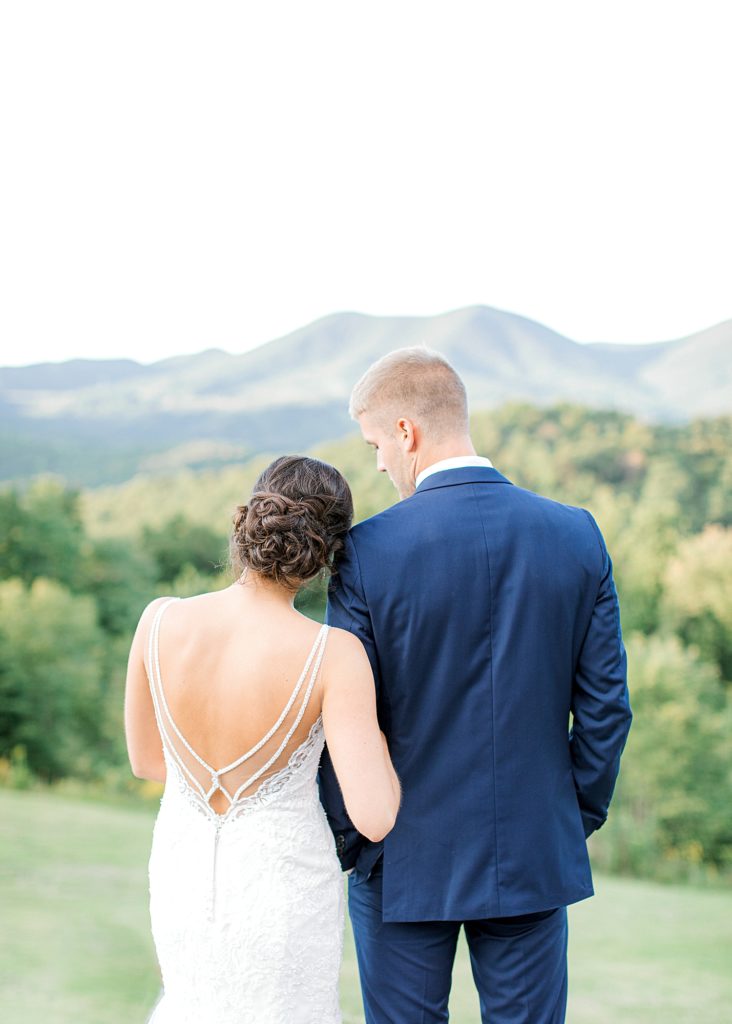 Bride and groom looking at Blue Ridge Mountains.
