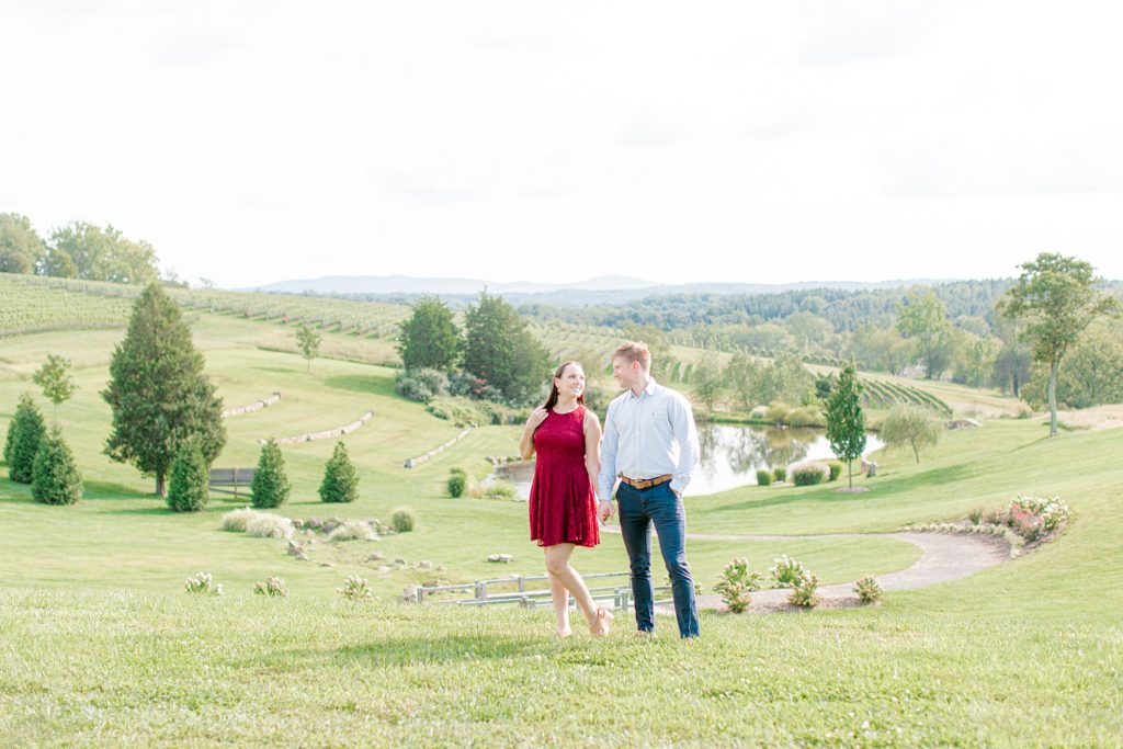 Couple posing in front of lake at Stone Tower Winery for engagement photos.