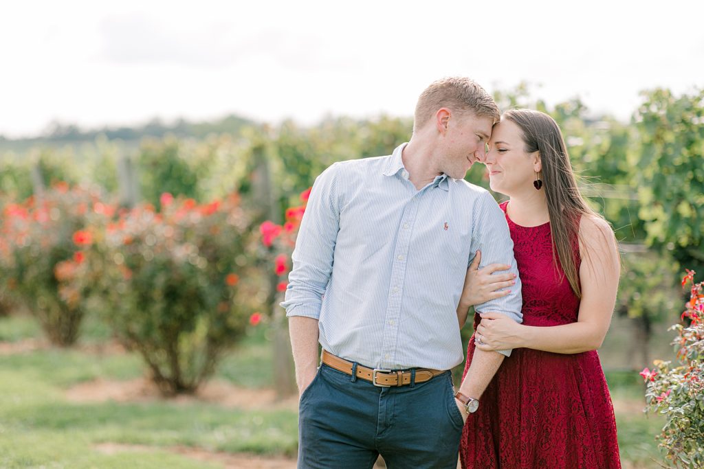 Couple posing for photos for engagement session at Stone Tower Winery in Leesburg, VA.