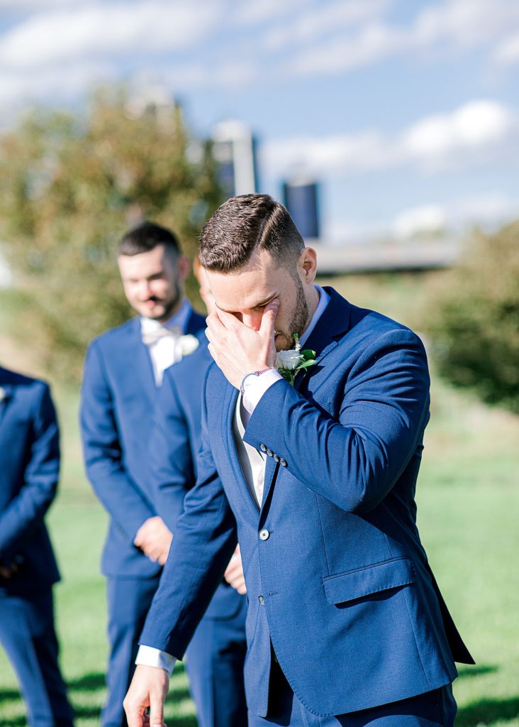 Groom's reaction to bride walking down the aisle.