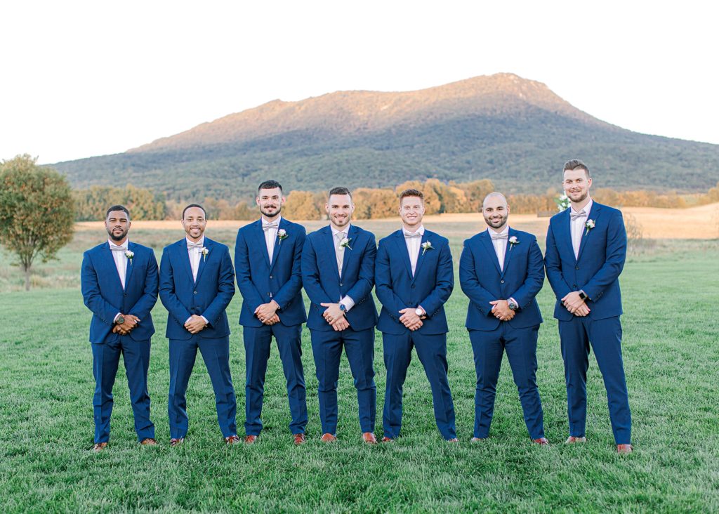 Groom and groomsmen smiling for photo at Harrisonburg wedding.