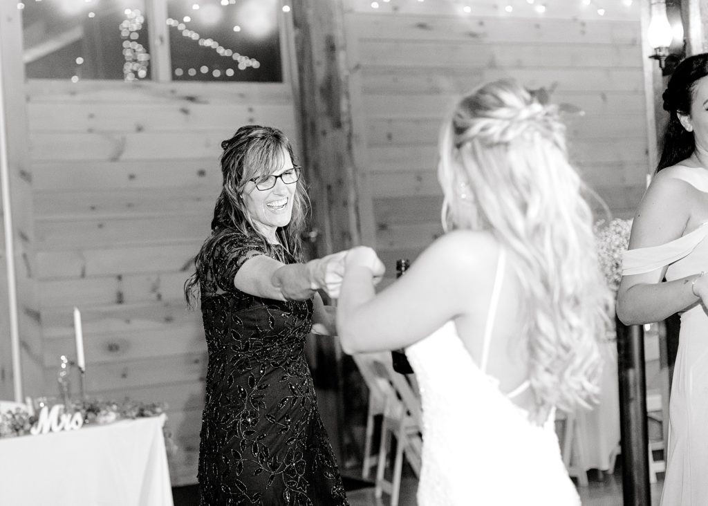 Photo of bride dancing with guest.