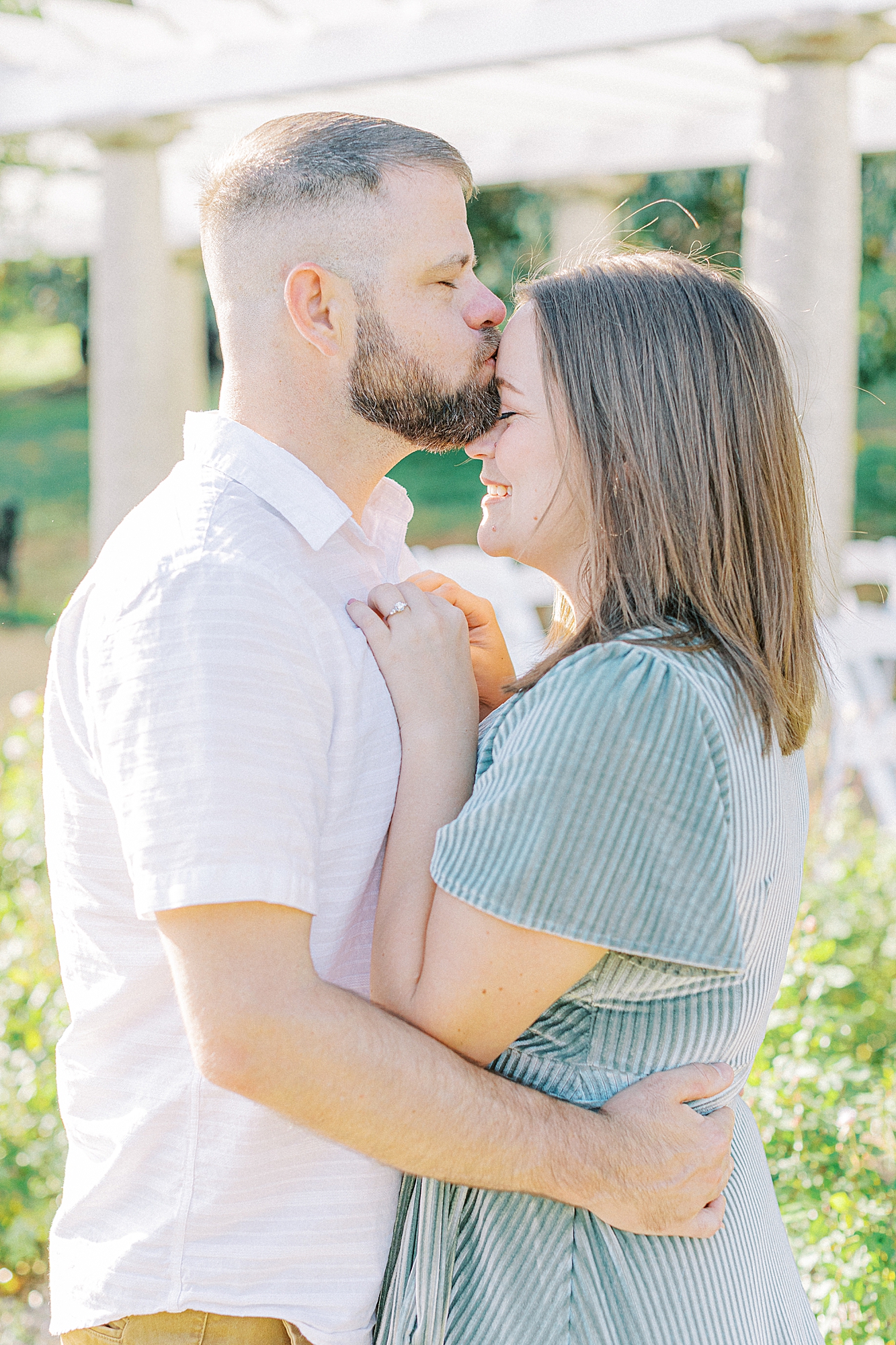 Man kissing woman's forehead for engagement portaits by Ashley Eagleson Photography.