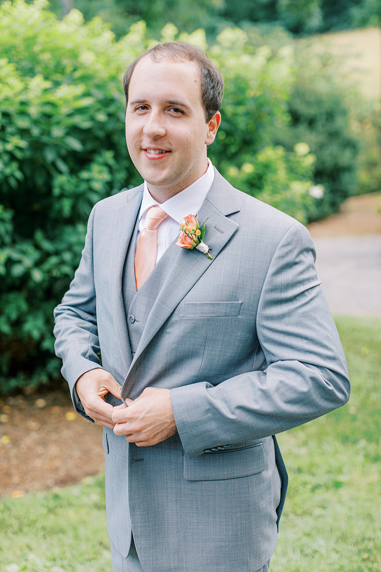 Groom buttoning suit.