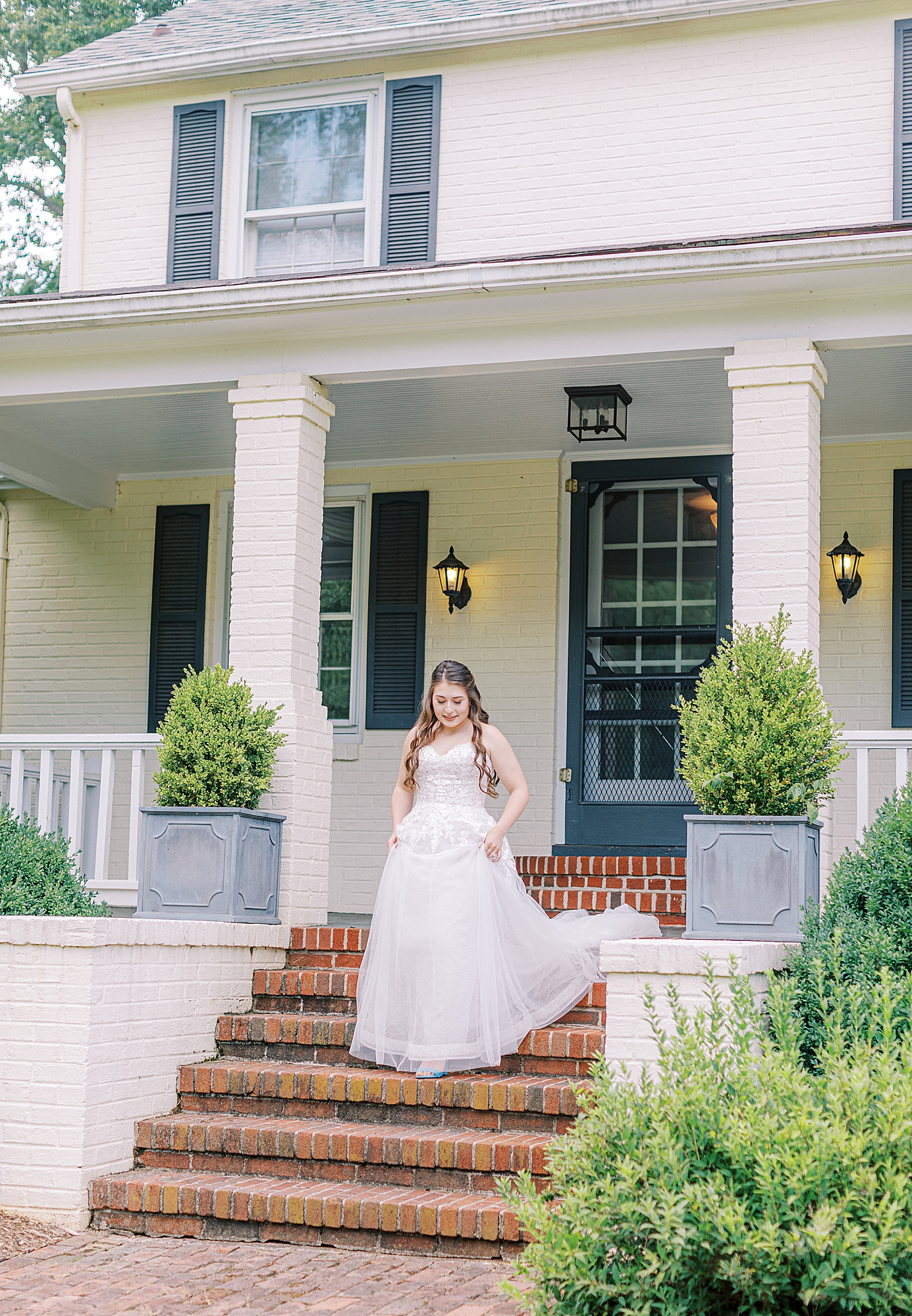Bride walking down the stairs at Spotswood Lodge.