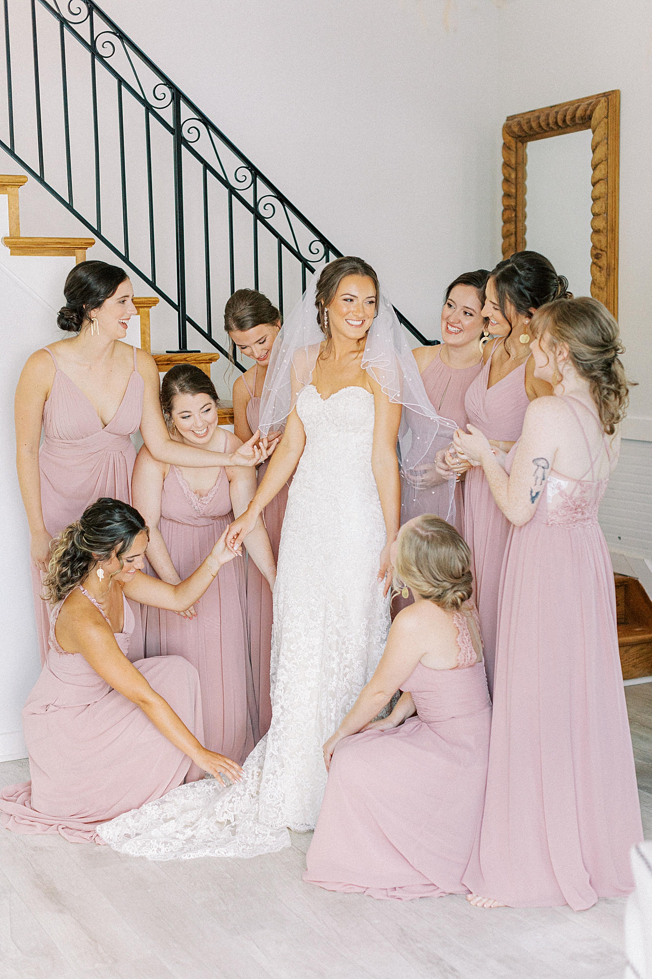 Bridesmaids helping bride with final touches before getting ready for ceremony at Richmond wedding venue, Alturia farm.