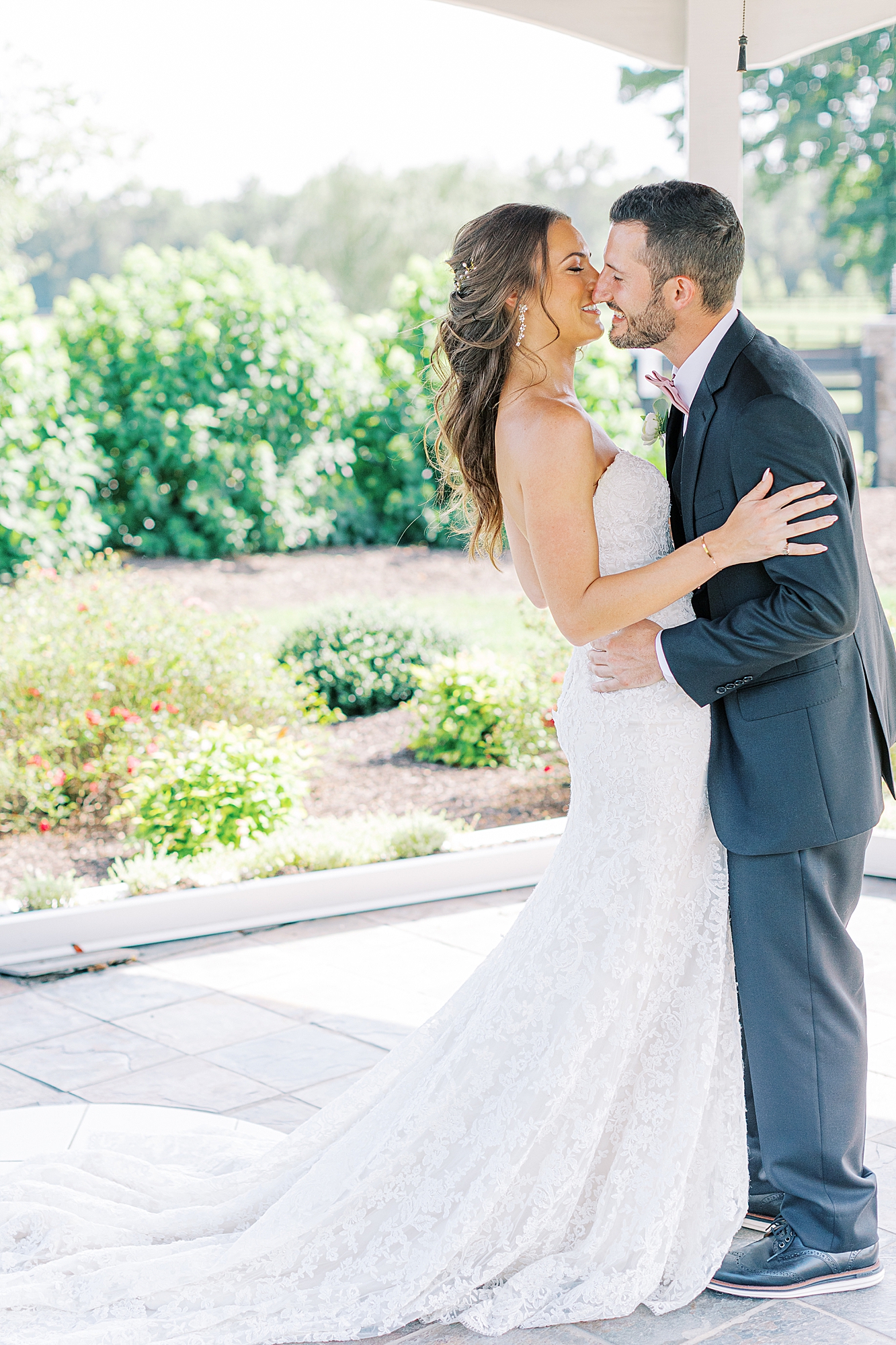 Bride and groom share a kiss after first look taken by Ashley Eagleson Photography.