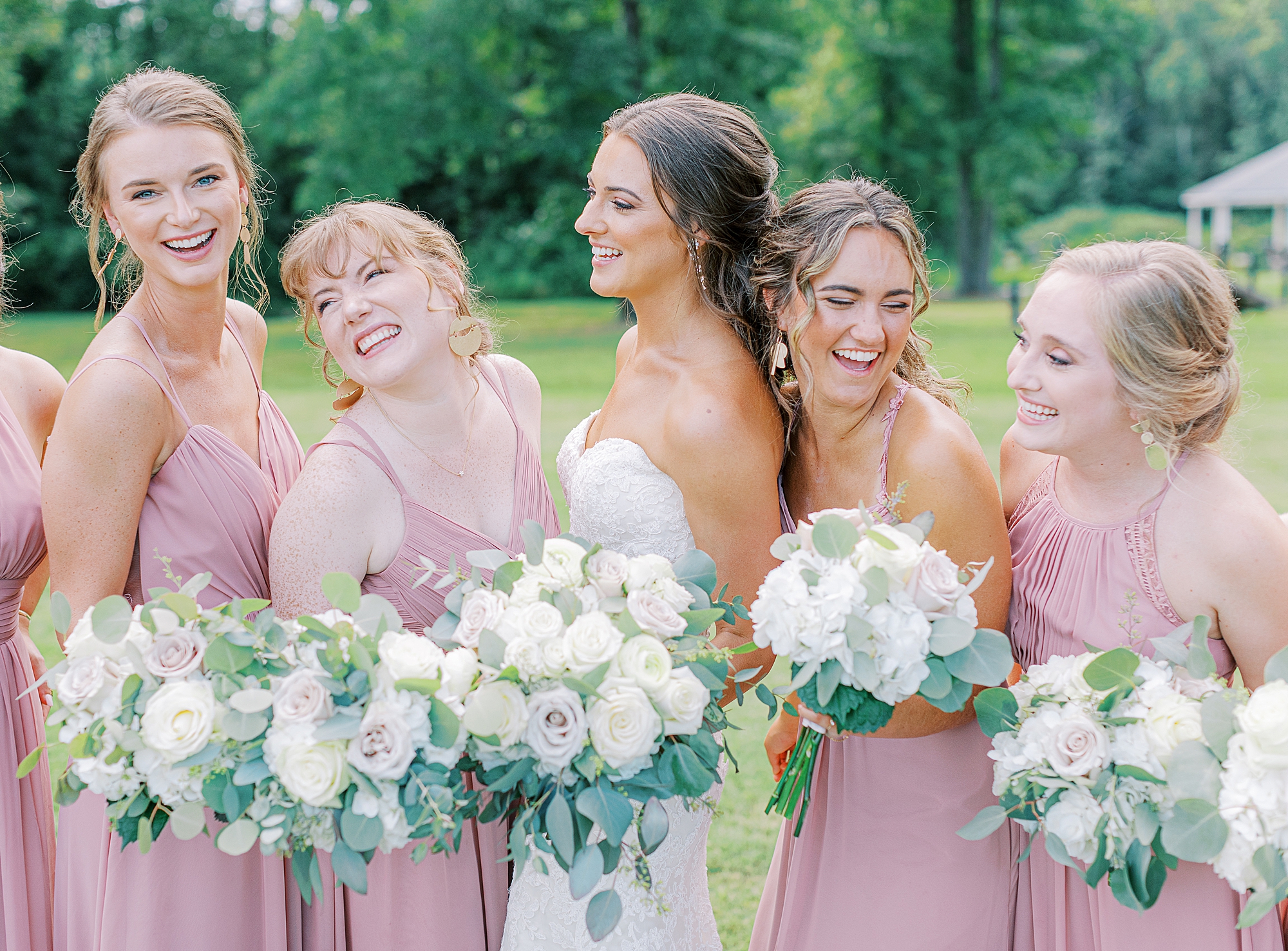 Bridesmaids and bride laughing.