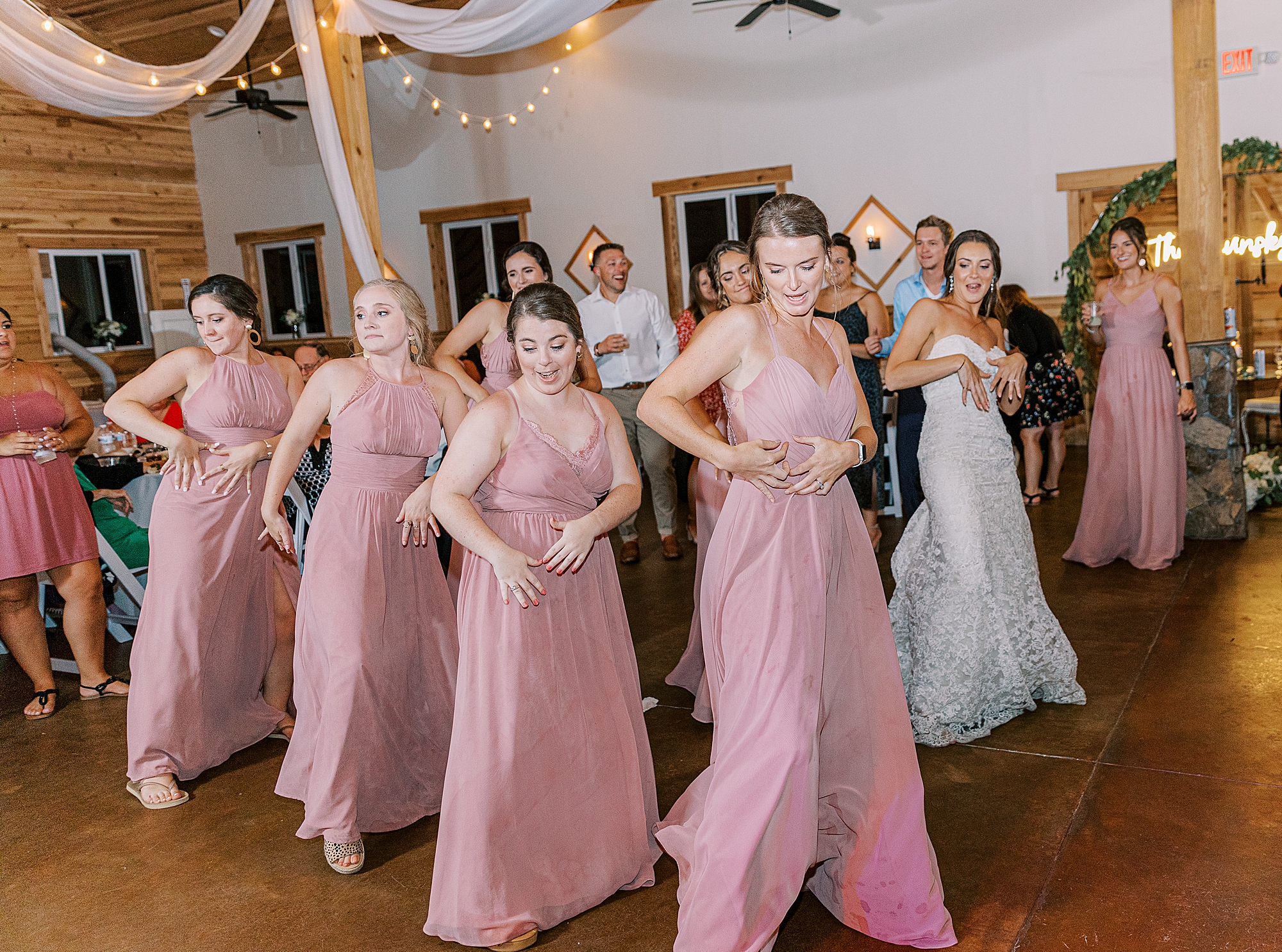 Coordinated dance between bridesmaids at wedding reception. 