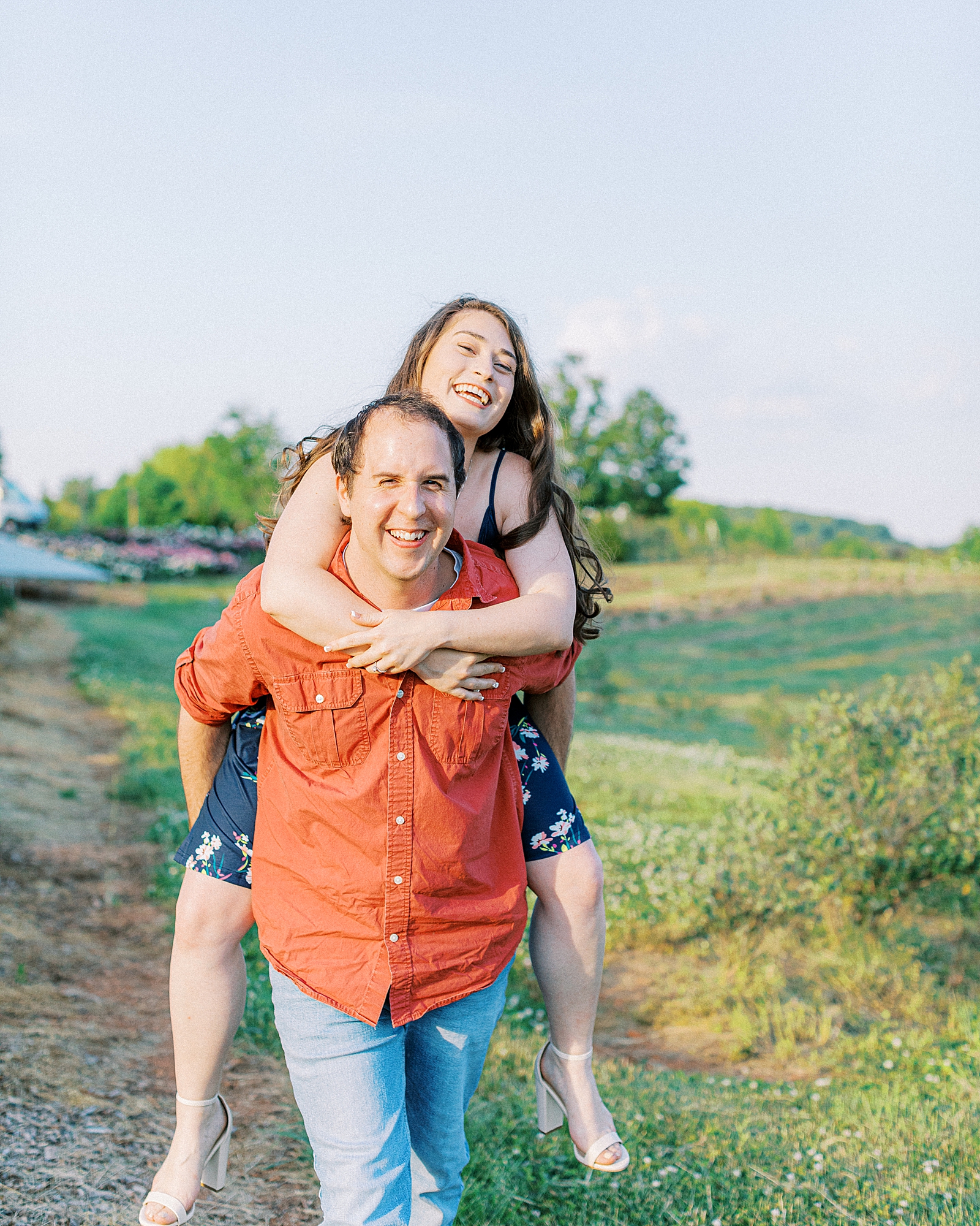 Woman laughing during piggy back ride.
