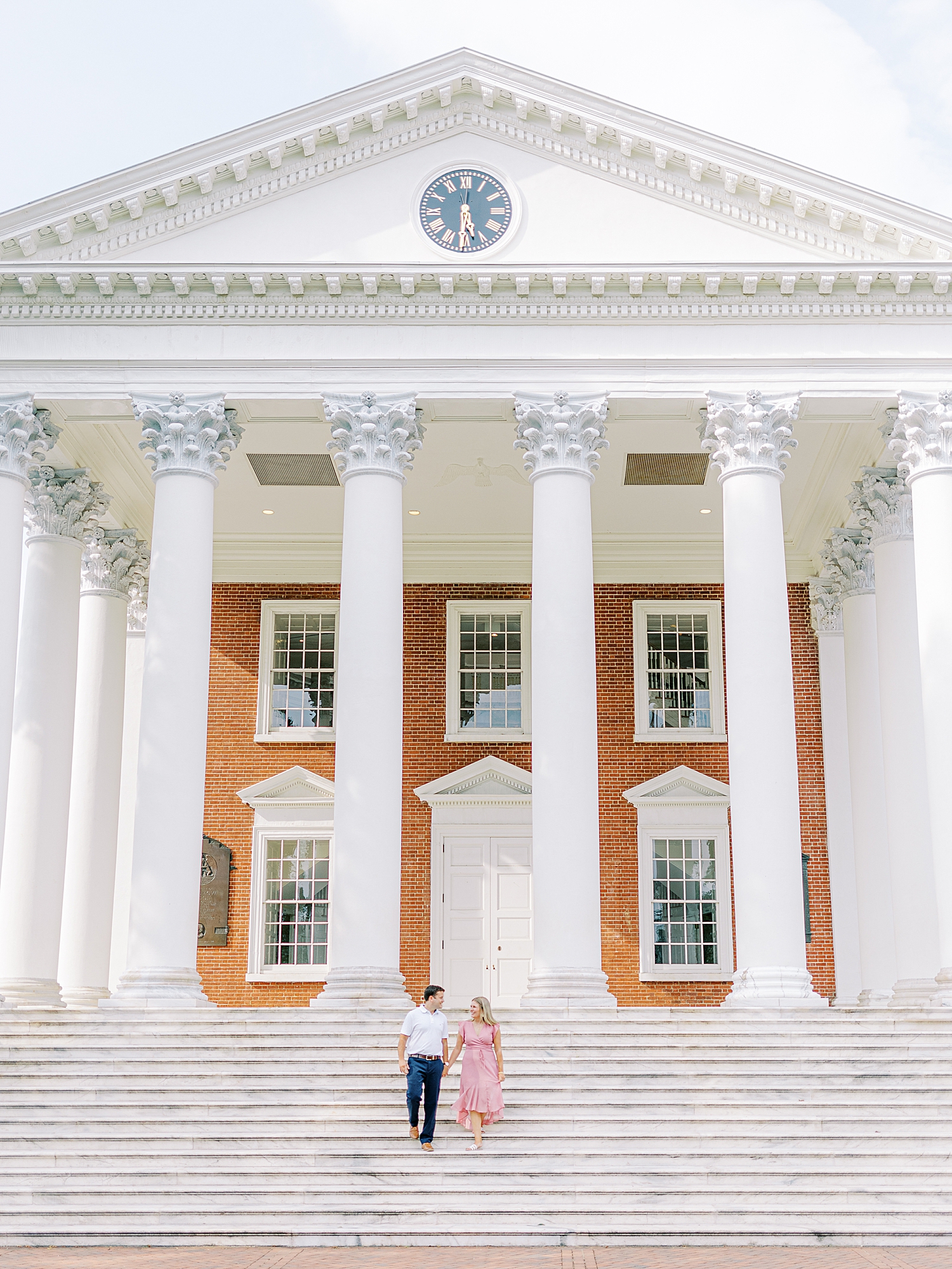 Couple walking down the steps of The Rotunda at UVA during engagement session.