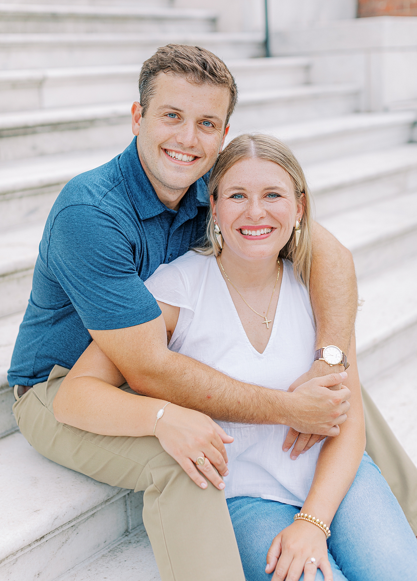 Couple sitting and smiling at camera during engagement session in Charlottesville, Virginia. 