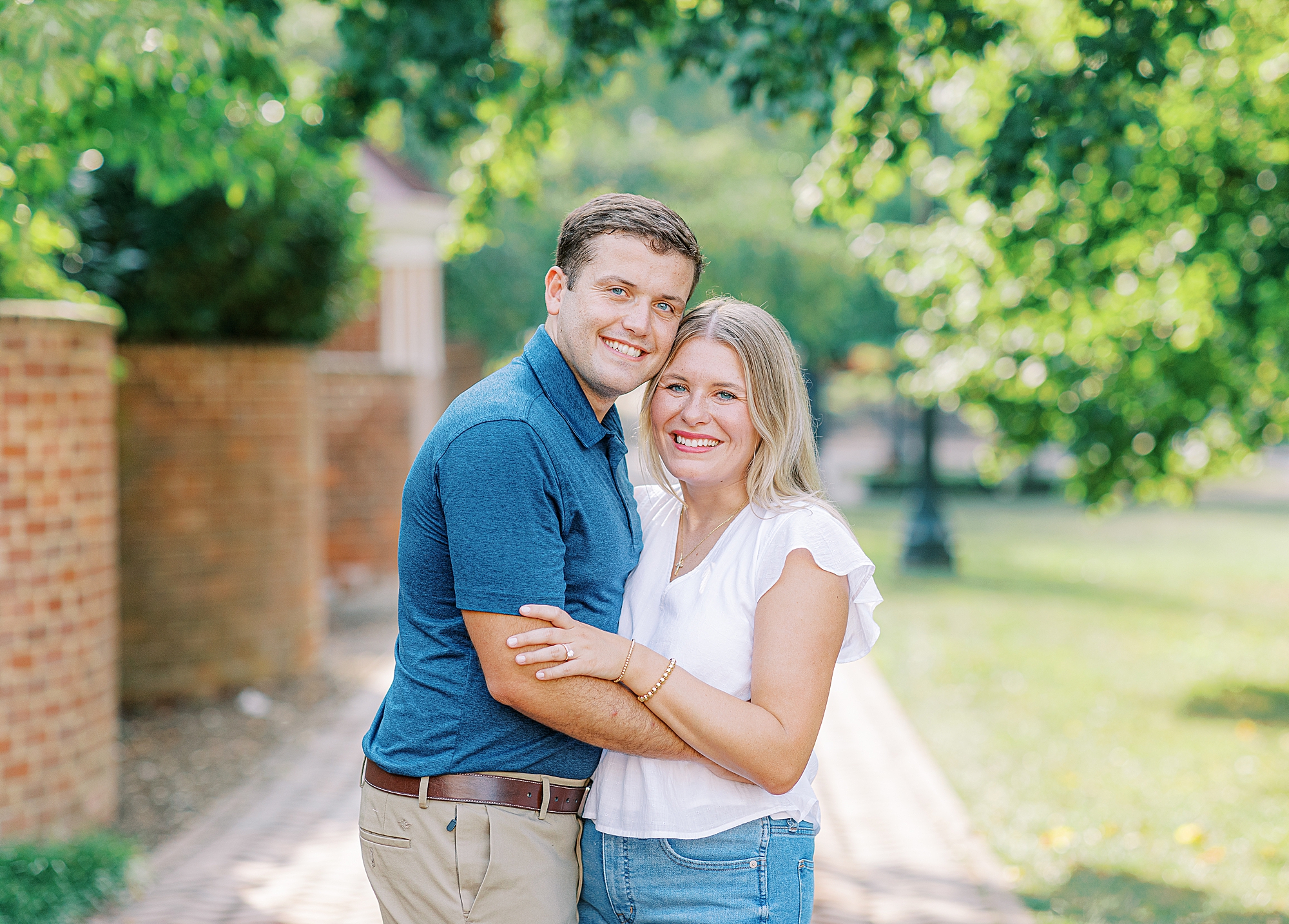 Ashley Eagleson Photography captures couple smiling at camera during summer engagement session.