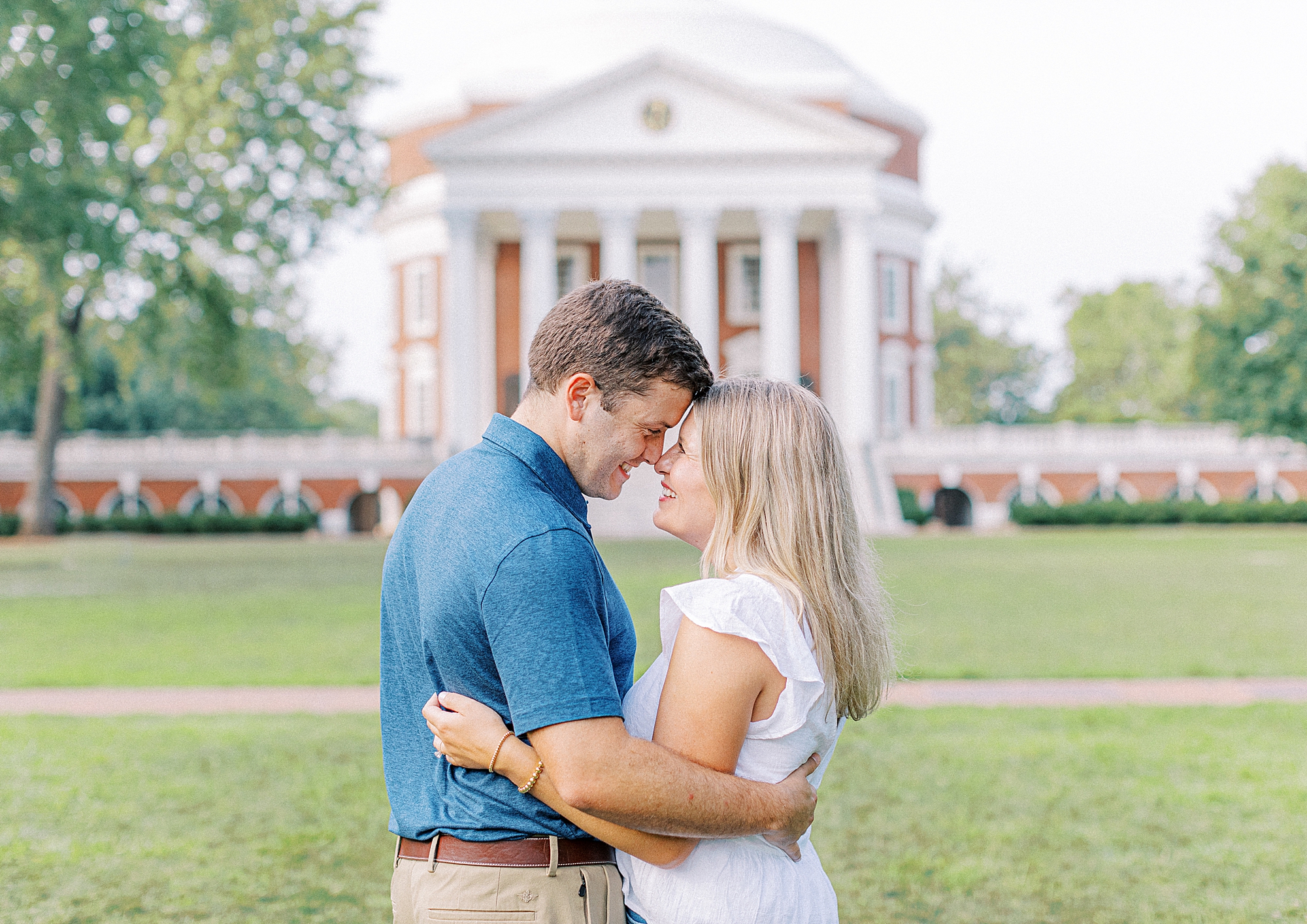 Couple on The Lawn at The University of Virginia snuggling into each other during engagement session.