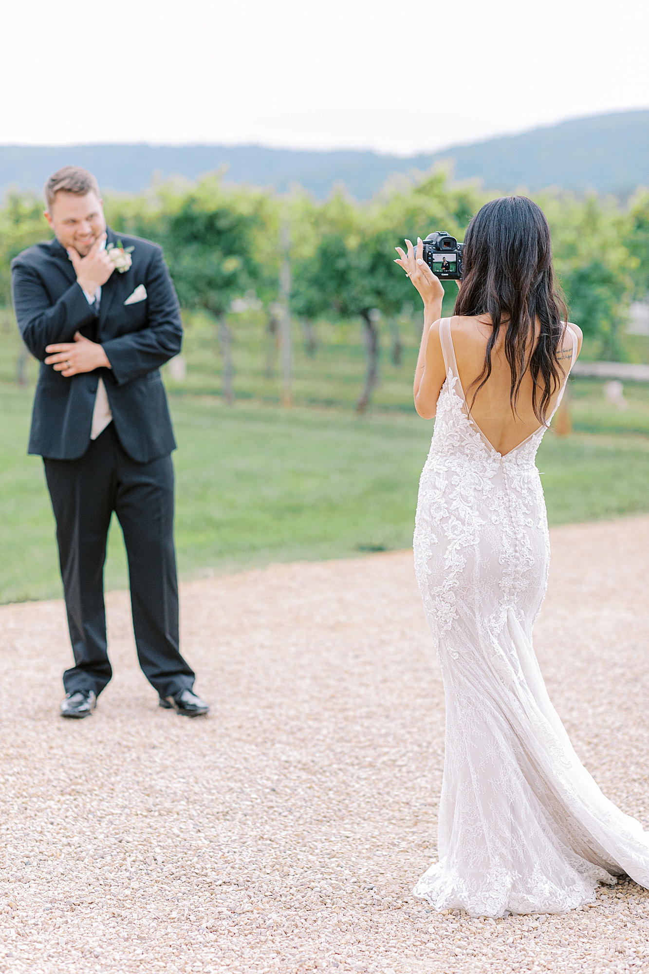 Bride taking photo of groom.
