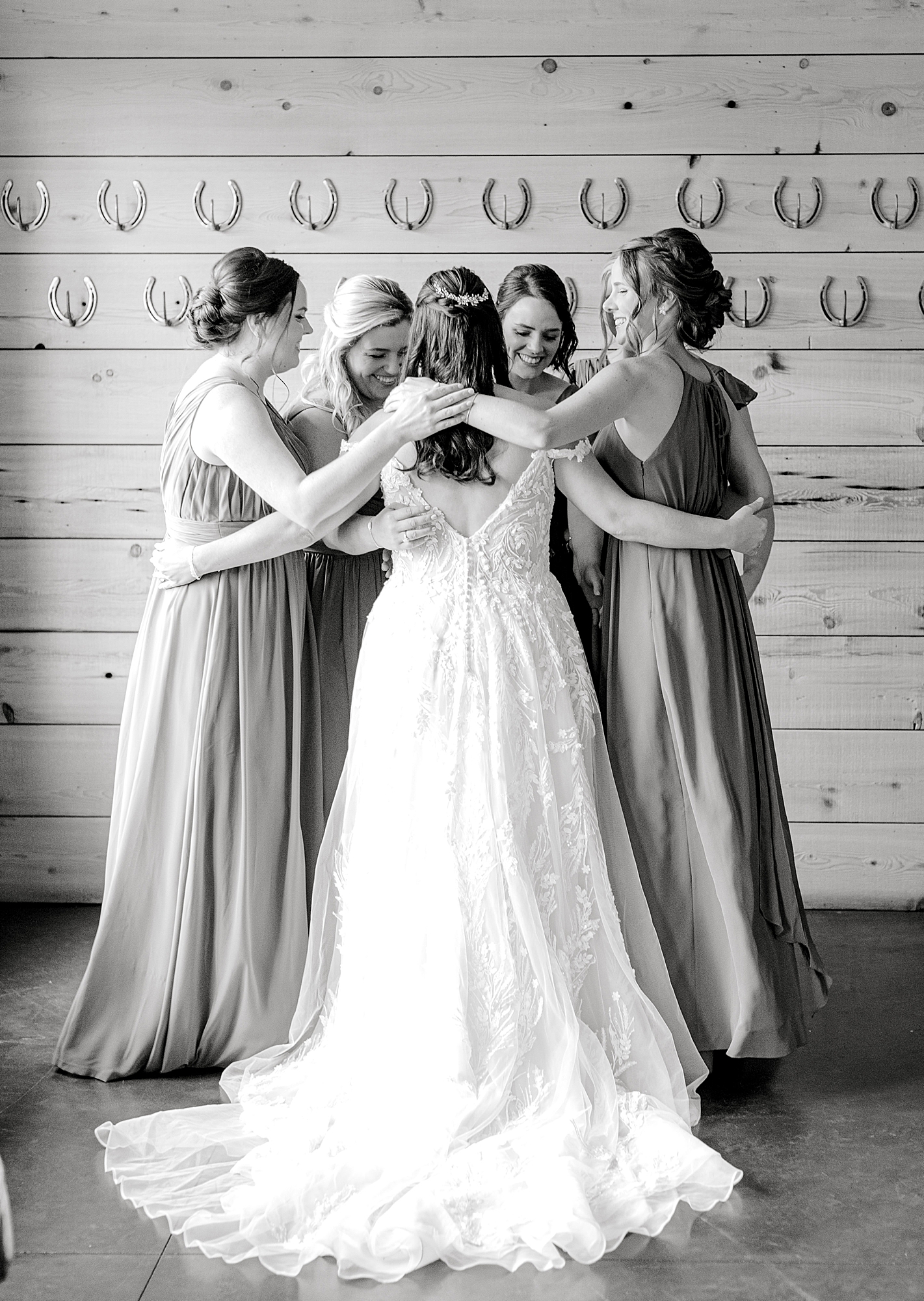 Bride hugging bridesmaids at King Family Vineyards wedding.