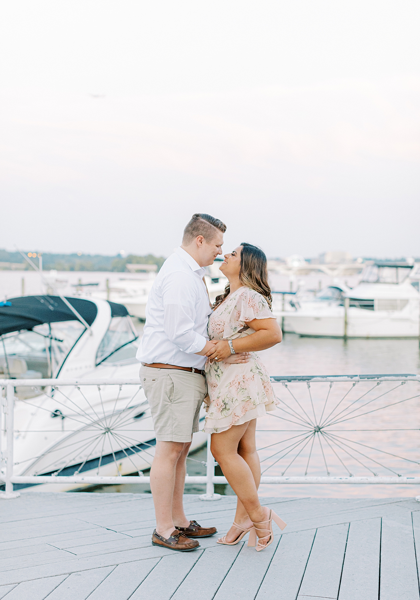 Couple smiling up at each other during Old Town Alexandria engagement photos.