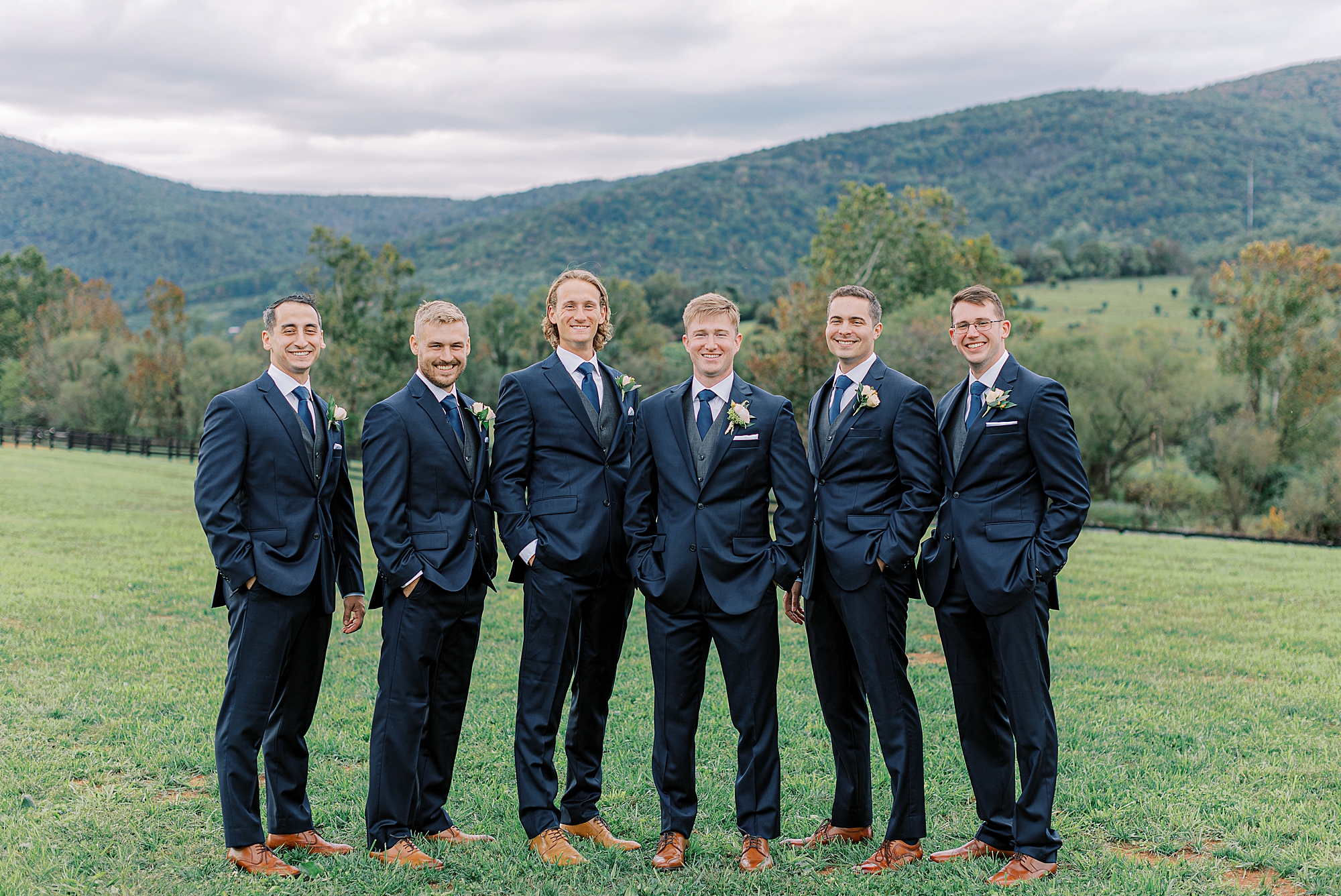Groom and groomsmen in blue suits.