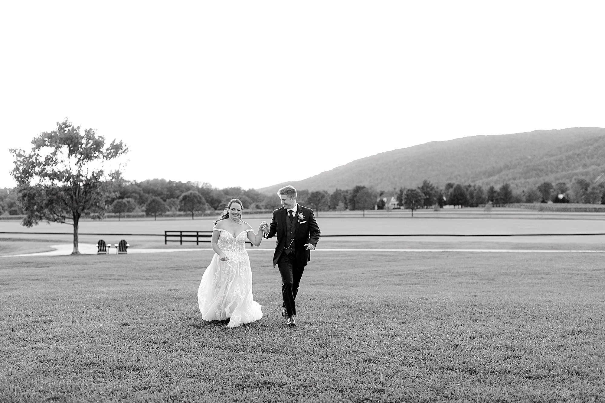 King Family Vineyard wedding with bride and groom running towards camera.