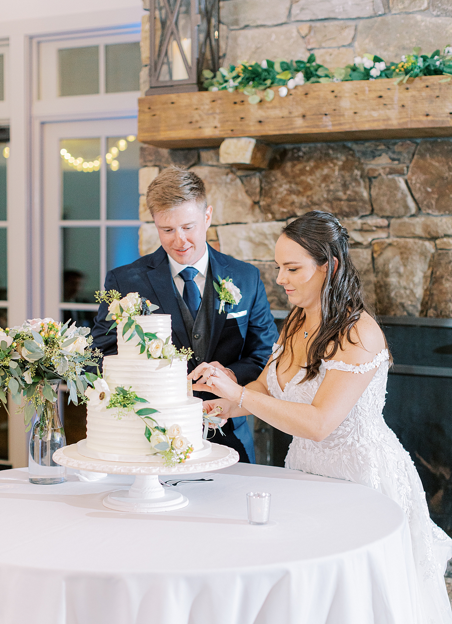 Bride and groom cutting cake made by Passionflower Cakes at King Family Vineyards wedding.