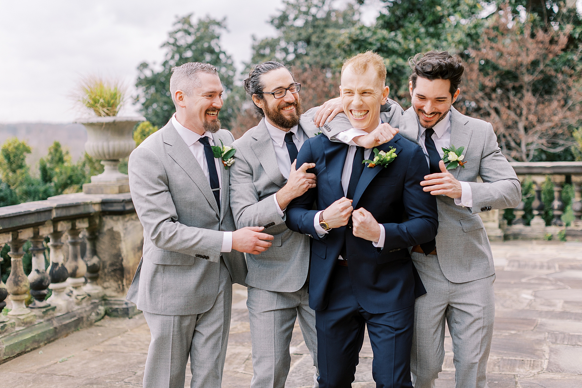 Candid groom and groomsmen photo taken by Richmond wedding photographer at The Branch Museum.