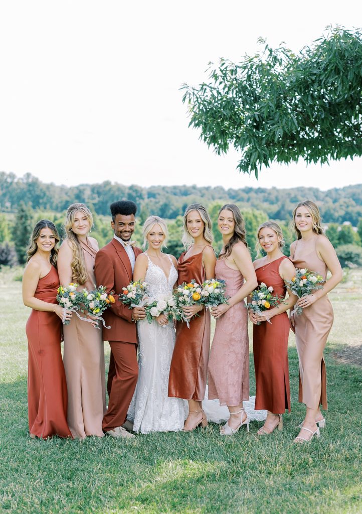 Bridesmaids wearing mixed colors and textures.