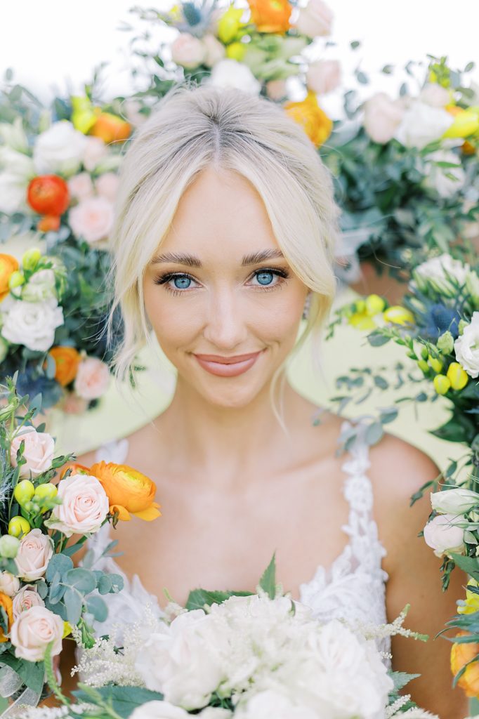 Creative bridal portrait with bouquets.