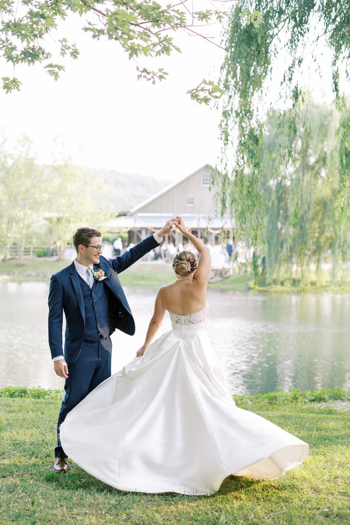 Portrait of bride and groom at Big Spring Farm lake.