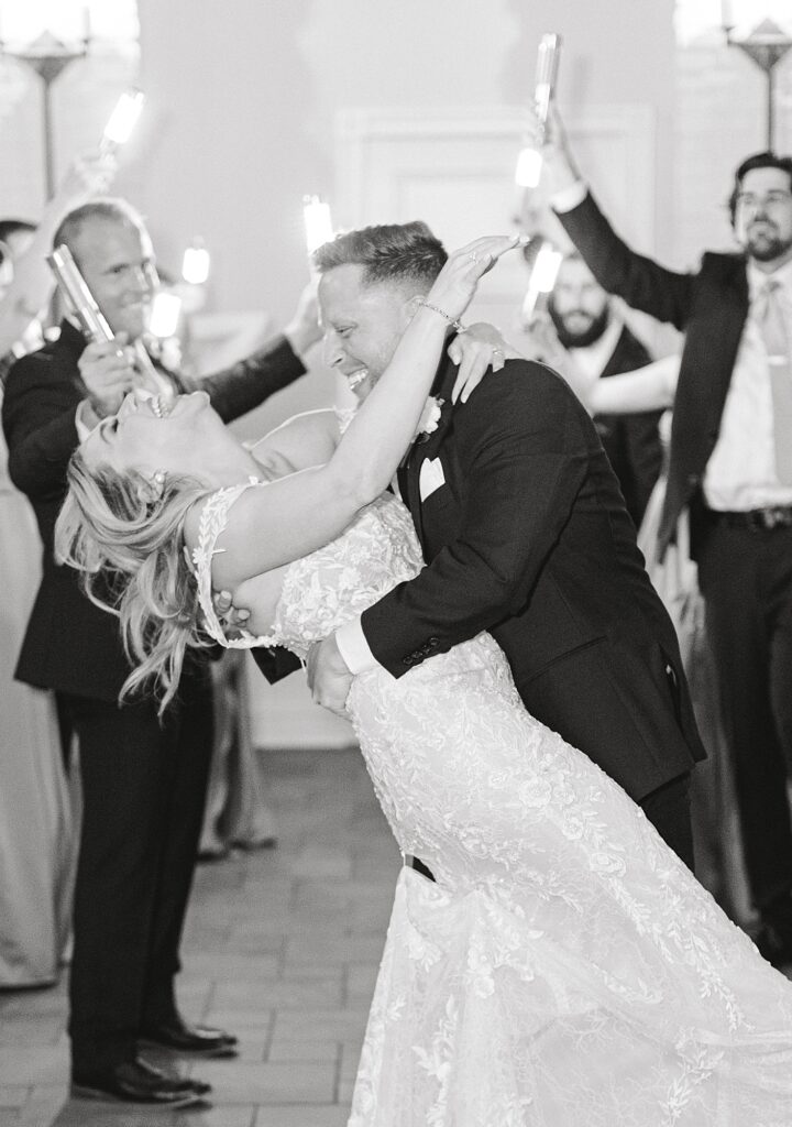 Black and white photo of bride and groom dancing. 