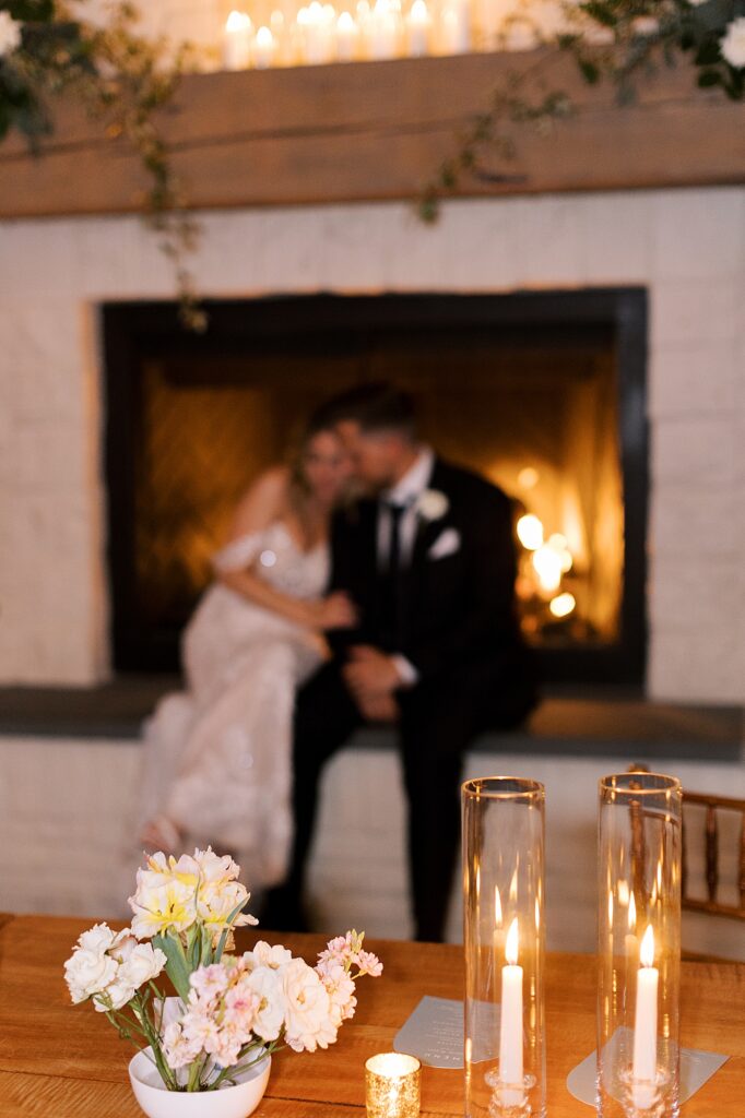 Bride and groom sitting in front of fireplace during Early Mountain Vineyards wedding.