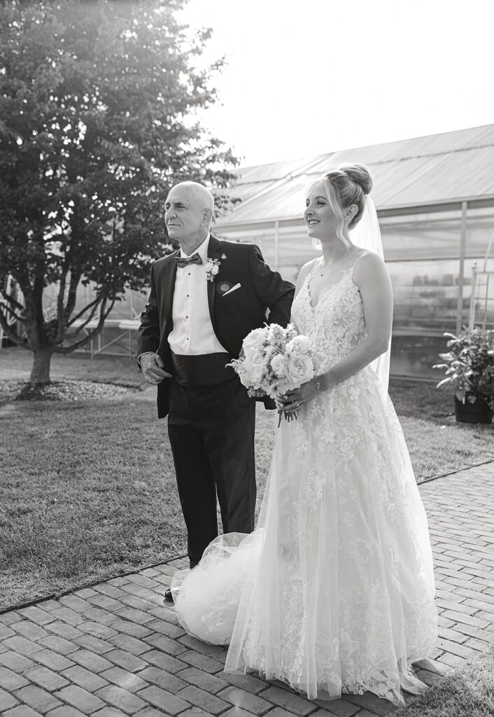 Black and white photo of bride about to walk down aisle.