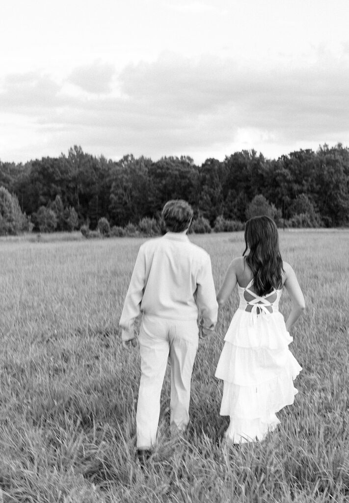 Blurry photo of couple running into field during outdoor engagement session in Richmond.