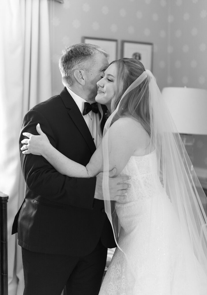 Father of the bride seeing bride for the first time sharing an emotional hug.